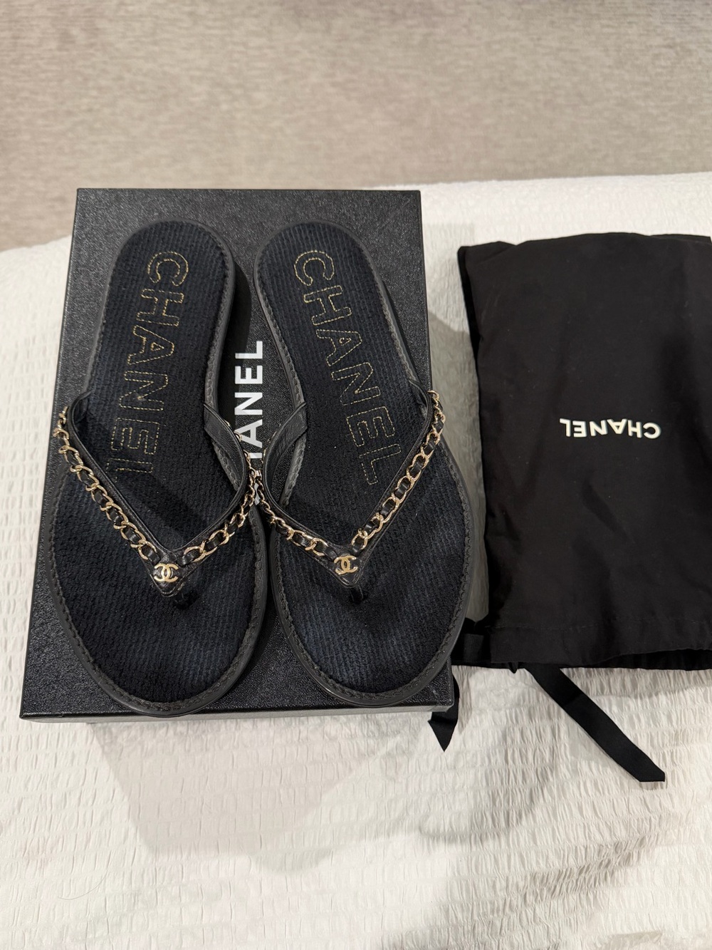 CHANEL Black Flip Flop Sandals with Gold Chain Accent